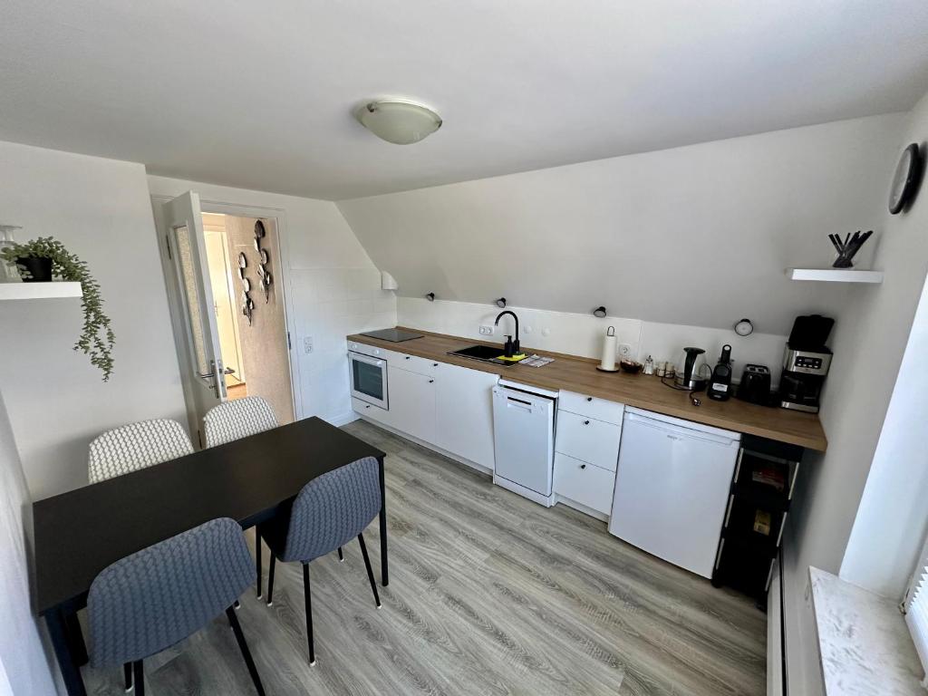 a kitchen with a table and chairs in a room at Casa Corina in Norden
