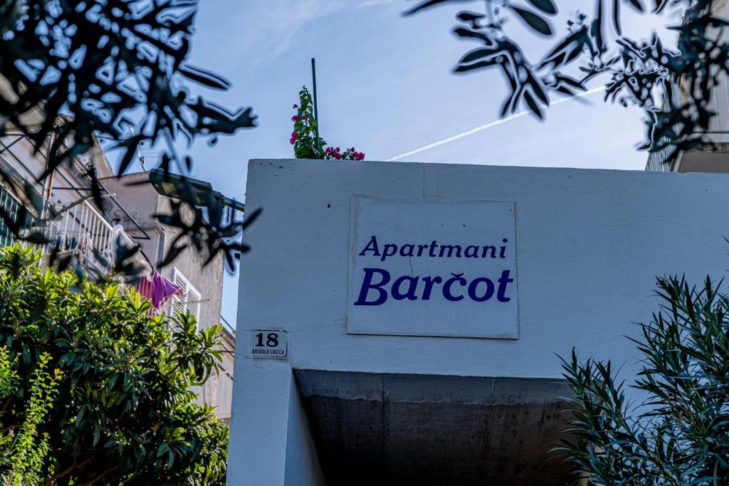 a sign for an apartment barot on a building at Apartments Barcot in Hvar