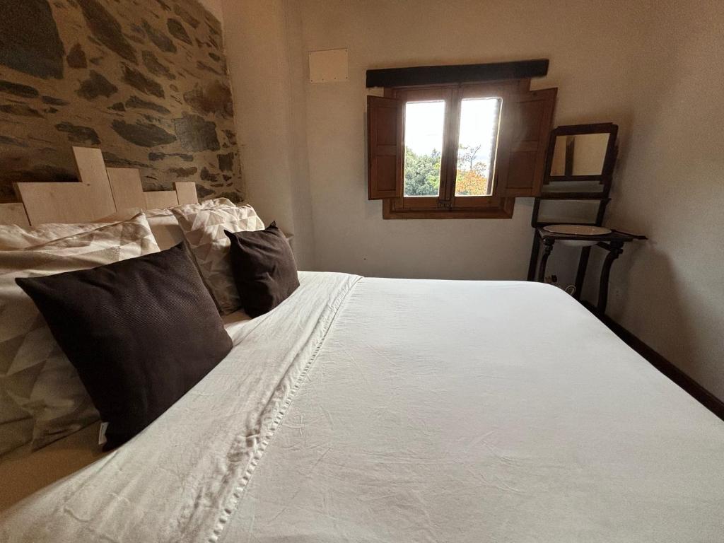 Postel nebo postele na pokoji v ubytování Can Rovira de Fogars