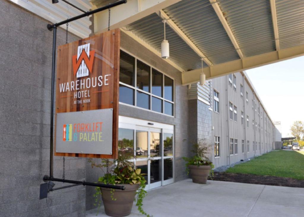 a building with a sign that reads warehouse hotel it consult table at Warehouse Hotel at The Nook in Manheim