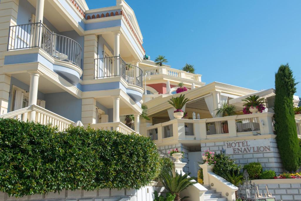 a large apartment building with balconies and plants at Enavlion Hotel in Chrysi Ammoudia