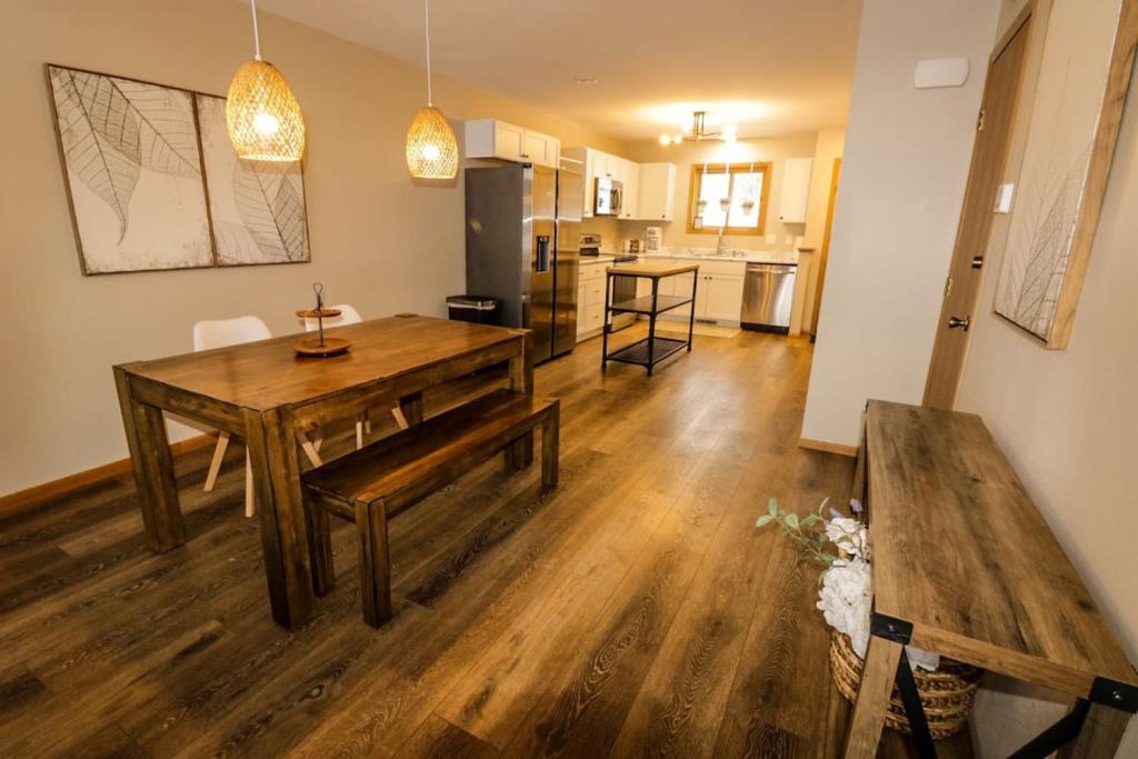 a living room with a wooden table and a kitchen at Waterfront Boho Retreat in Wisconsin Dells