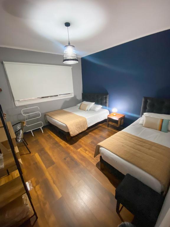 Postel nebo postele na pokoji v ubytování TQCaleta Providencia Barrio Italia