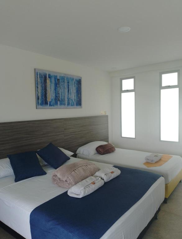 Postel nebo postele na pokoji v ubytování HOTEl PALO GRANDE CF PEREIRA