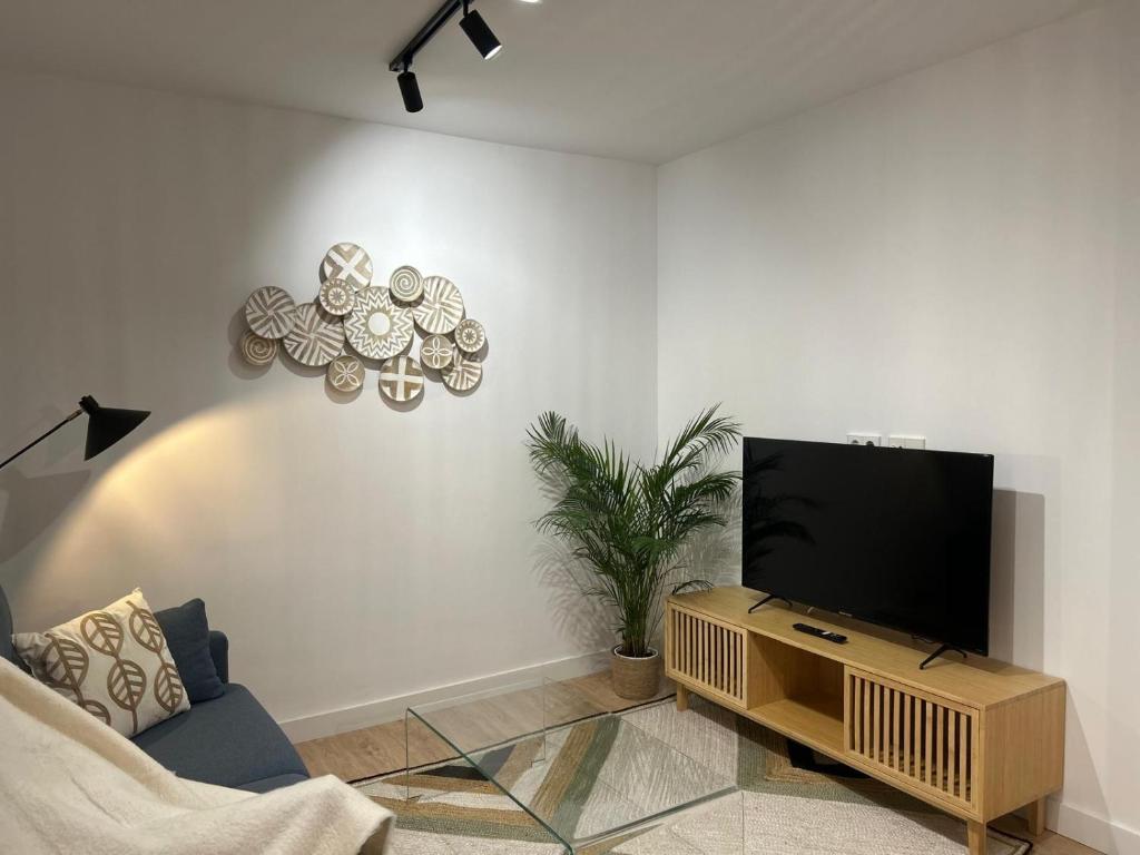 a living room with a flat screen tv on a wall at Loft Atemporal, centro de Ciudad Real in Ciudad Real