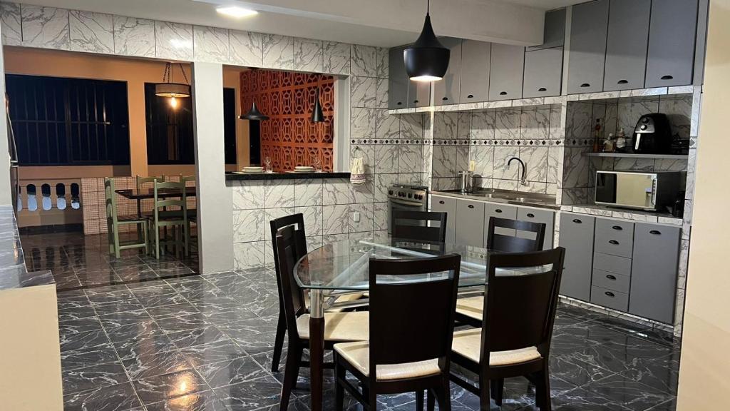 a kitchen with a glass table and chairs at Casa Naza in Areia