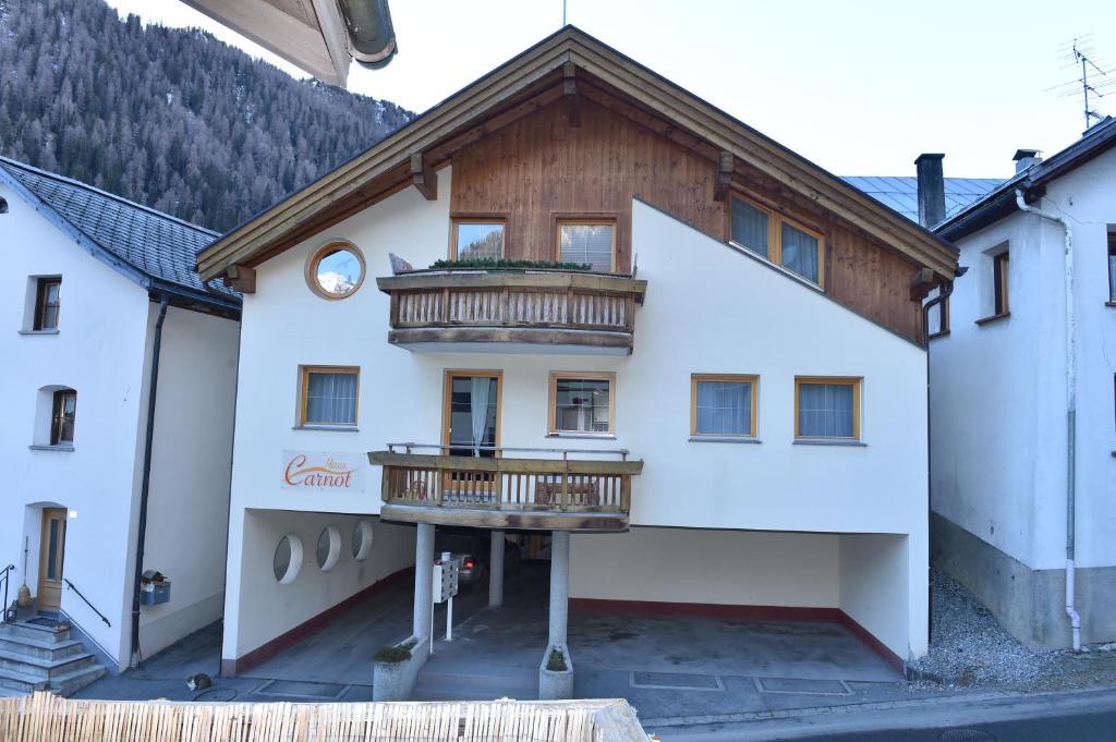 a building with a balcony on the side of it at Haus Carnot in Samnaun