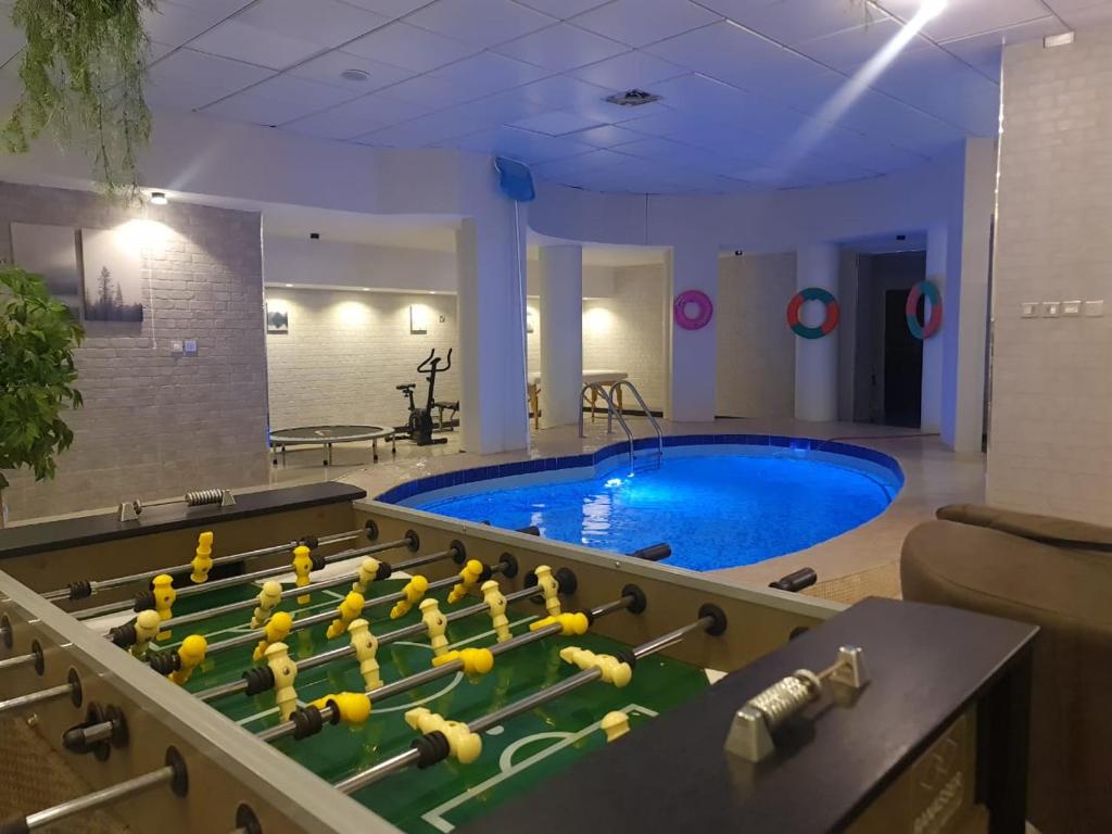 a pool with a bunch of balls on a table in a room at شاليه قطر الندى - الطائف in Taif