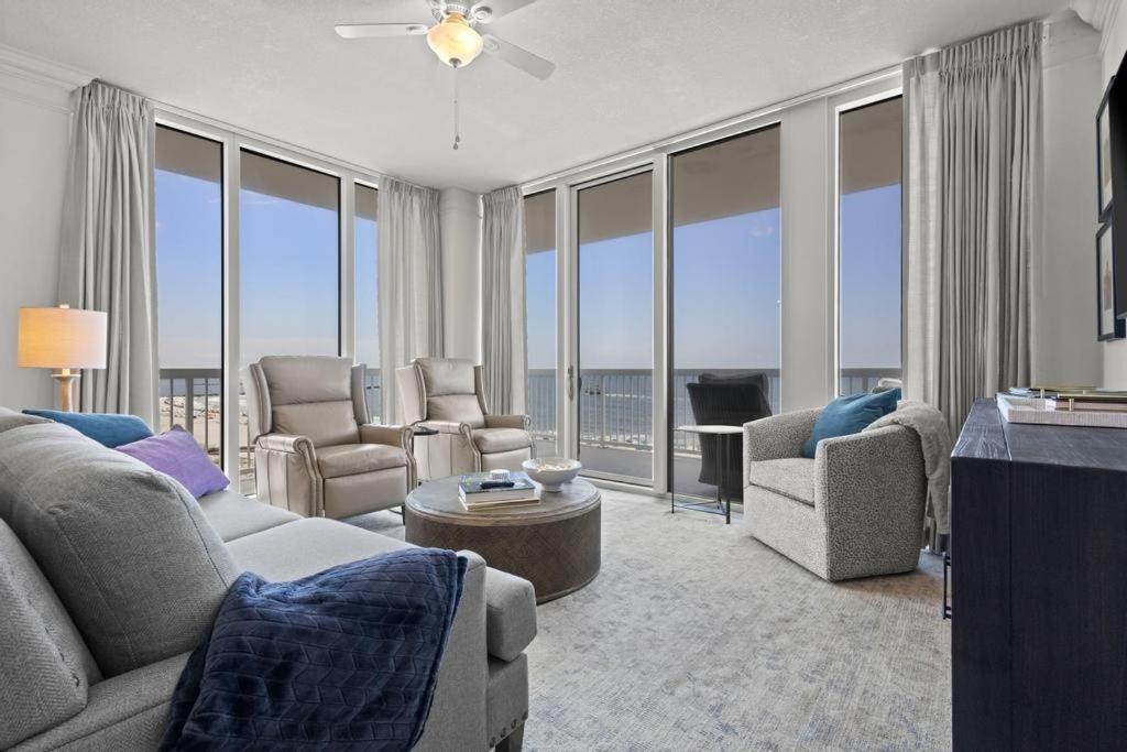 a living room with a couch and chairs and windows at Perdido Dunes Tower 6E condo in Orange Beach
