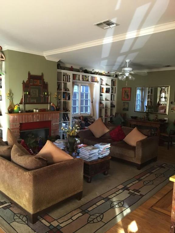 a living room with two couches and a fireplace at Elaine's Hollywood Bed & Breakfast in Los Angeles