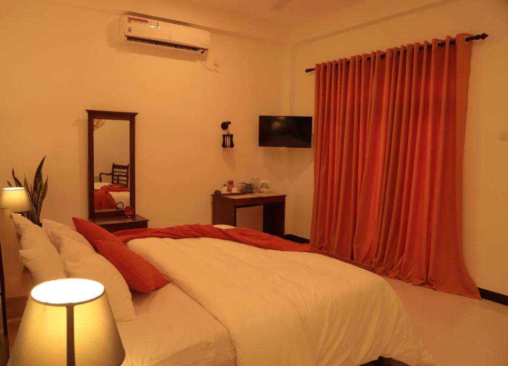 Postel nebo postele na pokoji v ubytování The Cattleya Guest House Sigiriya
