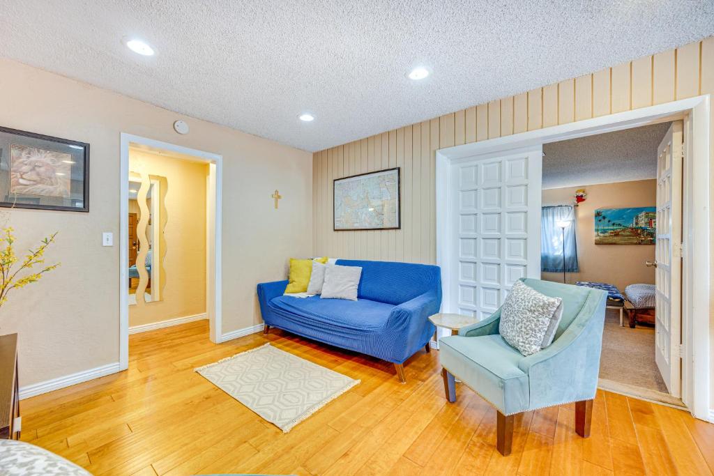 a living room with a blue couch and a chair at Cozy Colorado Springs Home Near Garden of the Gods in Colorado Springs