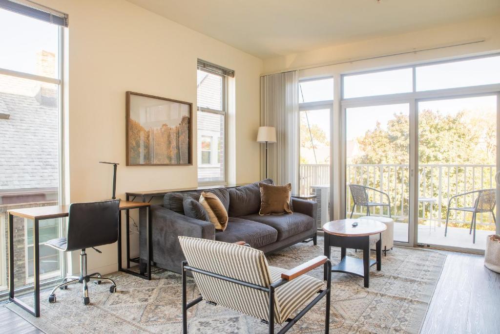 a living room with a couch and a table at East Side Luxury 1BR Apt - Near Brady and Fiserv with Balcony in Milwaukee