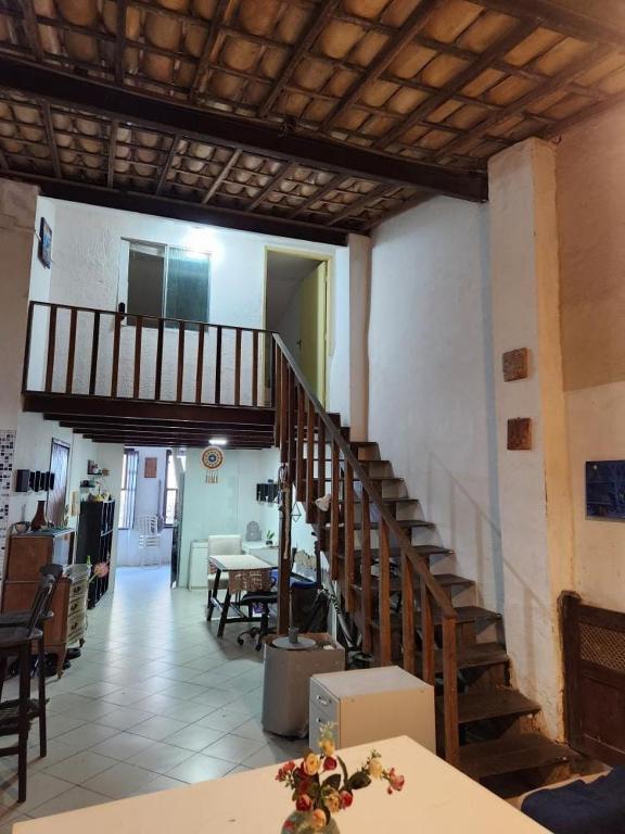 a living room with a staircase and a dining room at Katai in Salvador