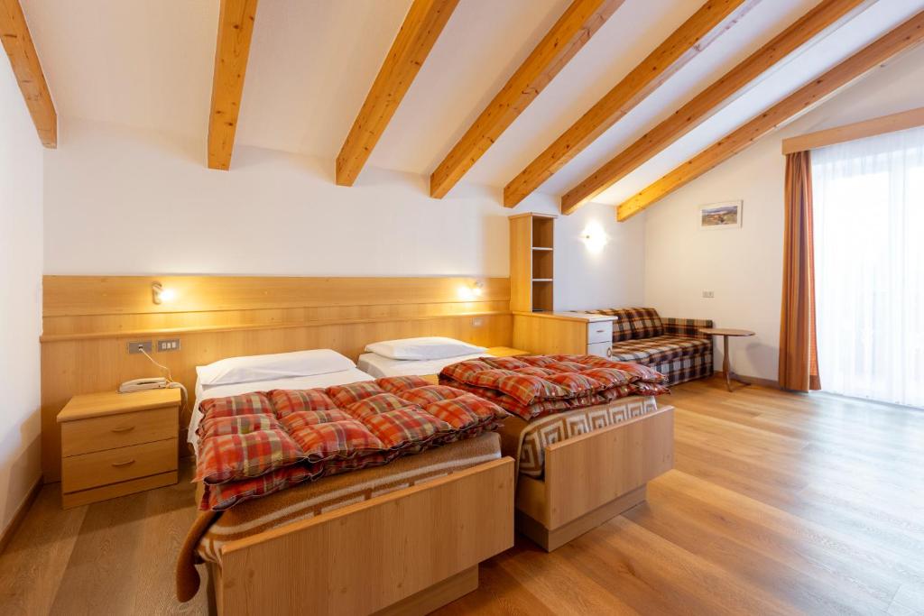 Postel nebo postele na pokoji v ubytování Hotel Cristallo