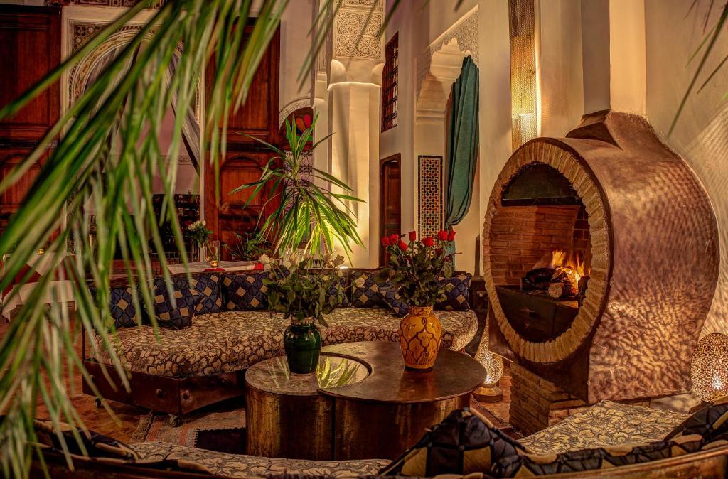 a living room with a couch and a fireplace at Riad Almaz in Fez