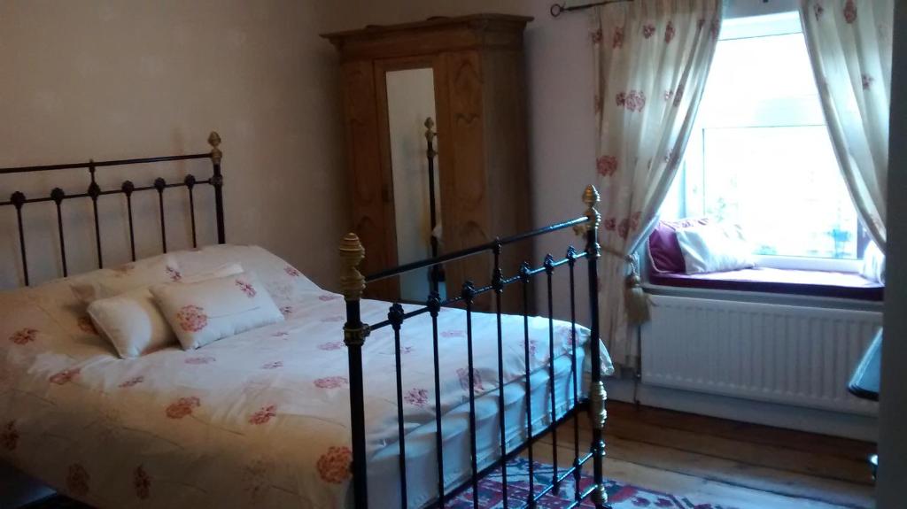 a bedroom with a bed and a window at Angate Cottage in Wolsingham