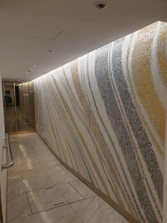 a wall in a building with a curtain at Sakura Sky Residence in Bangkok