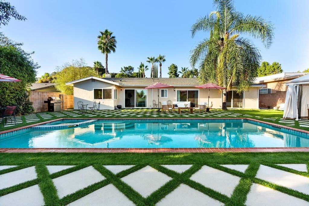a swimming pool in front of a house at Luxury 4BD and 3BA in Topanga Oasis with Pool, Spa and Cabana in Glenview