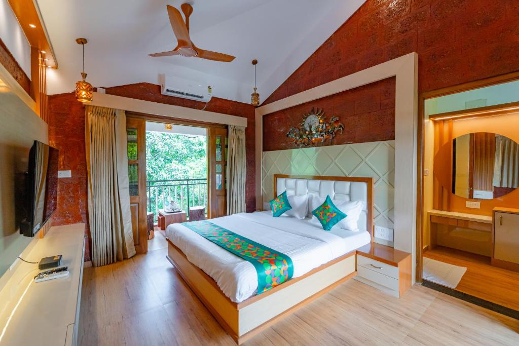 Кровать или кровати в номере Treebo Green Village Resort with Pool, Goa