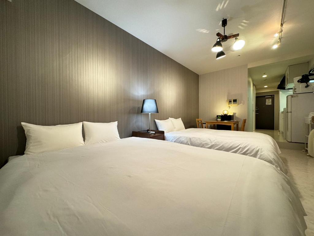 Postel nebo postele na pokoji v ubytování マルチステイ大阪天満