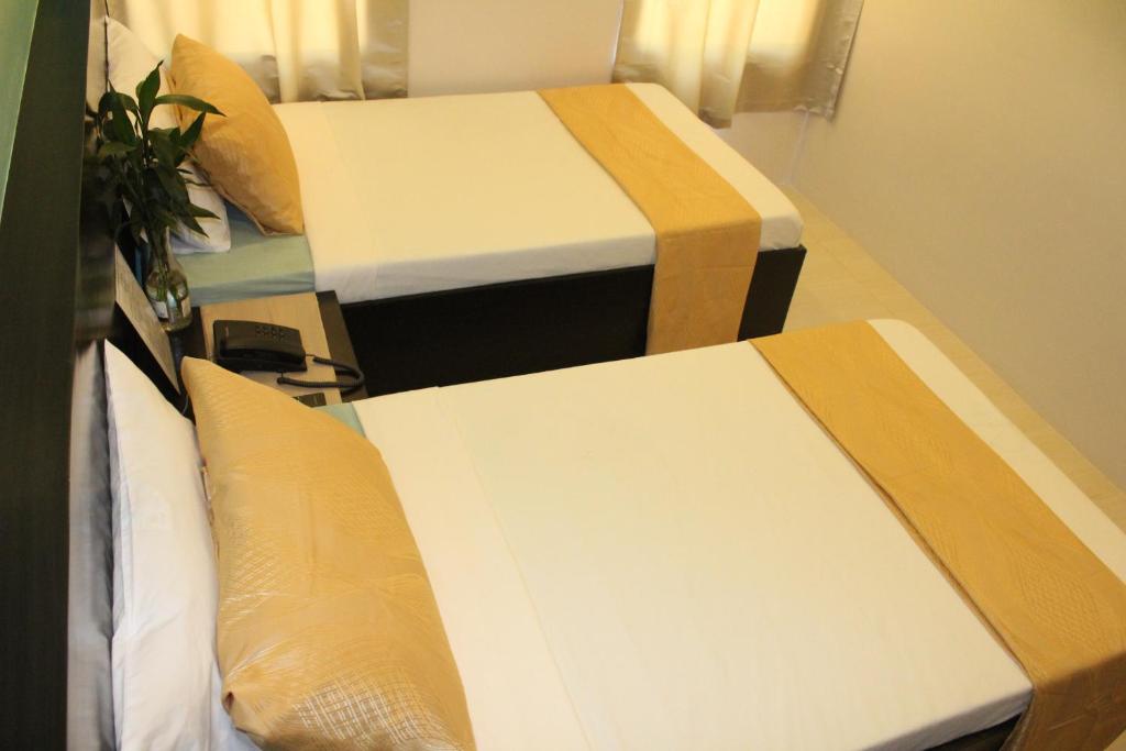 Postel nebo postele na pokoji v ubytování Coron Visitors Hotel