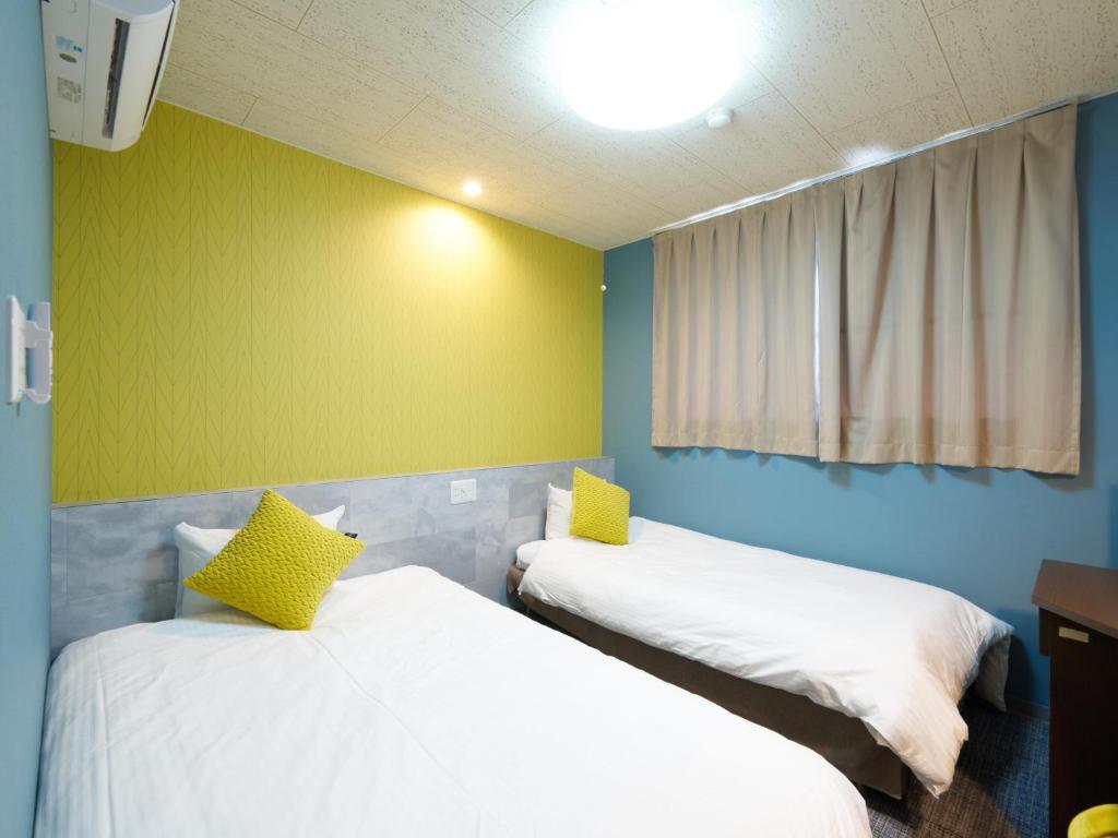 Postel nebo postele na pokoji v ubytování Hotel Village