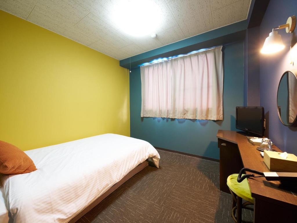 Postel nebo postele na pokoji v ubytování Hotel Village