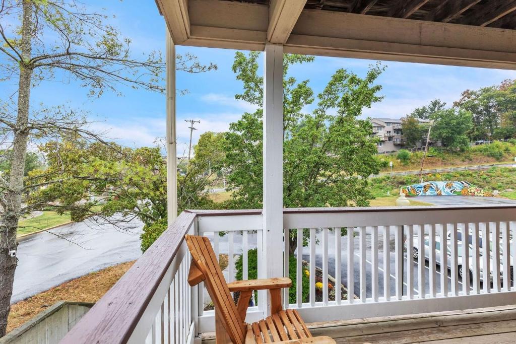a porch with a chair and a view of a river at Grand Wood Suites - 2nd Floor Front Side Signature Suite 201 in Nashville