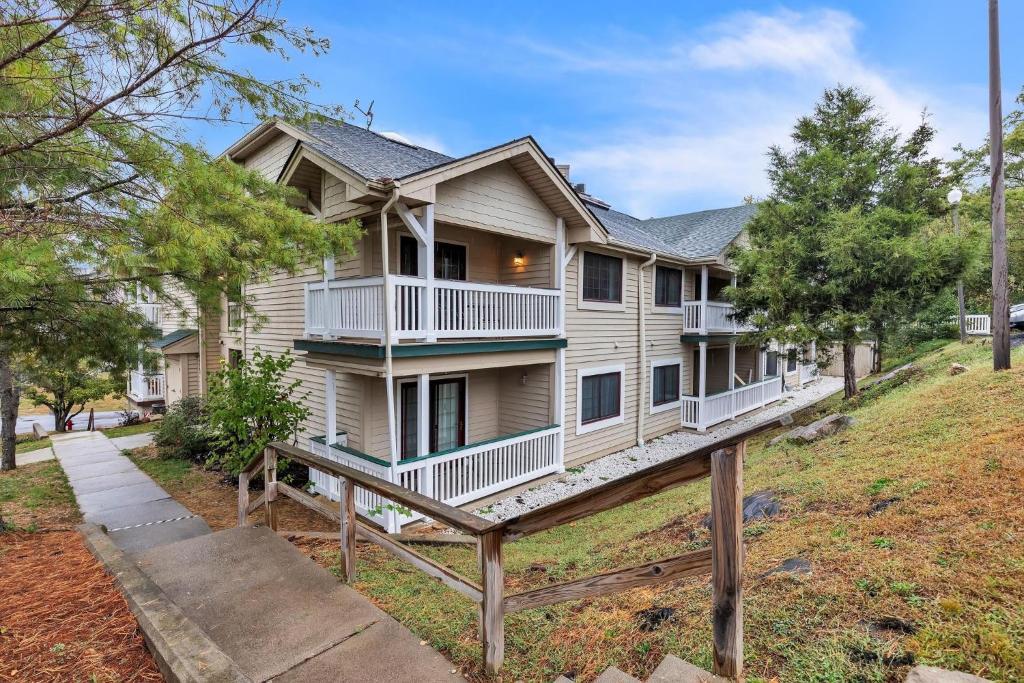 a house on a hill with a wooden rail at Grand Wood Suites - 2nd Floor Front Side Signature Suite 201 in Nashville