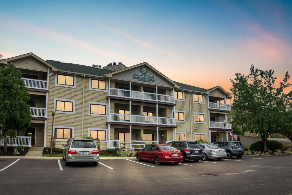a large apartment building with cars parked in a parking lot at Grand Wood Suites - 2nd Floor Front Side Signature Suite 201 in Nashville