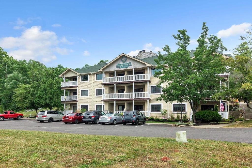 a large building with cars parked in a parking lot at Grand Wood Suites - 2nd Floor Front Side Signature Suite 201 in Nashville