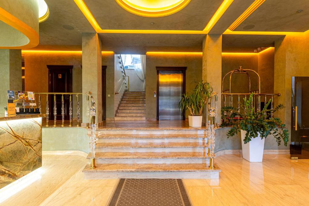 a lobby with stairs and a door in a building at MARION SPA Hotel & Spa - RENOVATION - Rooms, SPA area, Swimming pool, Reception, Restaurant, Lounge Bar, Hookah bar, Children's room, Parking, SPA and Breakfast included in the price in Bukovel