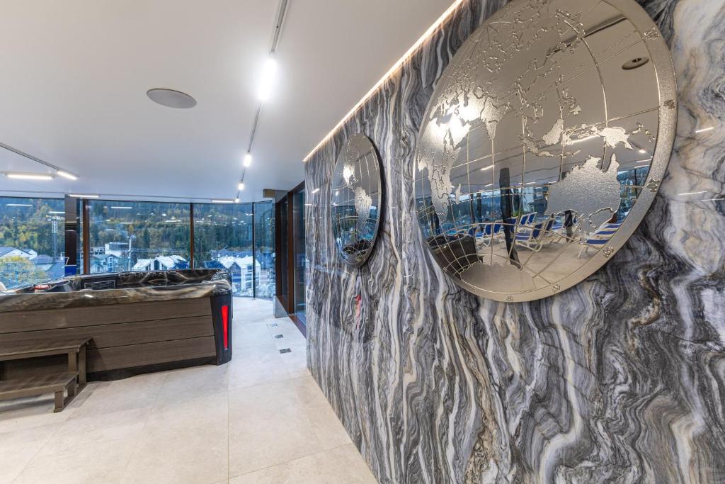 a large mirror on a wall in a room at MARION SPA Hotel & Spa - RENOVATION - Rooms, SPA area, Swimming pool, Reception, Restaurant, Lounge Bar, Hookah bar, Children's room, Parking, SPA and Breakfast included in the price in Bukovel