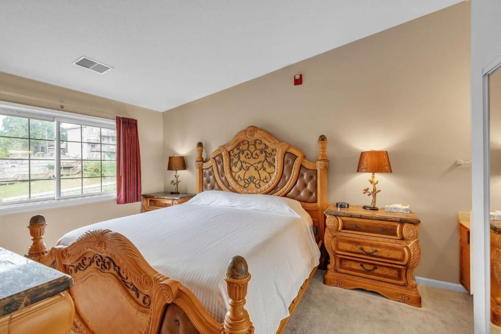 a bedroom with a large wooden bed and a window at Grand Wood Suites - 3rd Floor Front Side Corner Penthouse Suite 301 in Nashville
