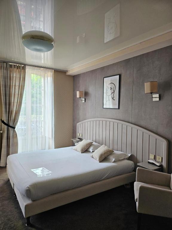Postel nebo postele na pokoji v ubytování Cit'Hotel le Challonge