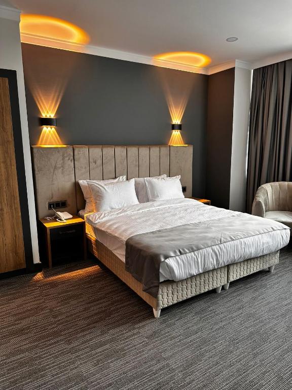 a bedroom with a large bed and two lamps at Home Plus Hotel in Istanbul