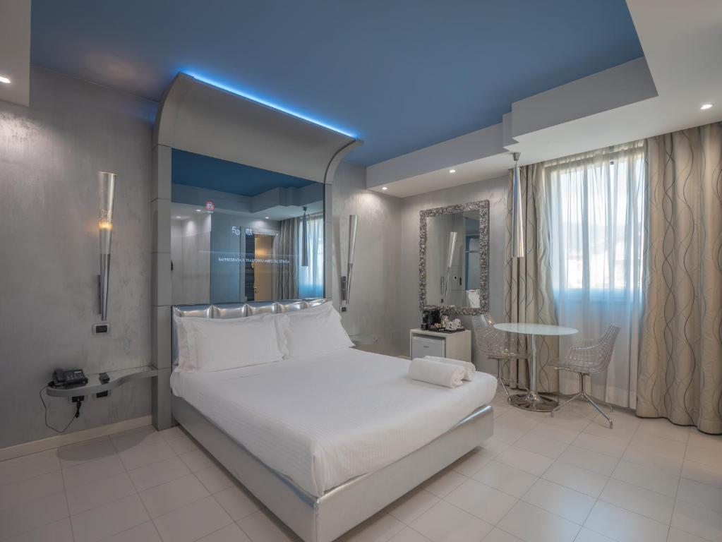A bed or beds in a room at San Valentino Hotel