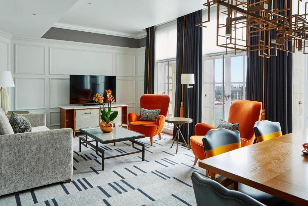 a living room with a couch and chairs and a table at London Marriott Hotel County Hall in London