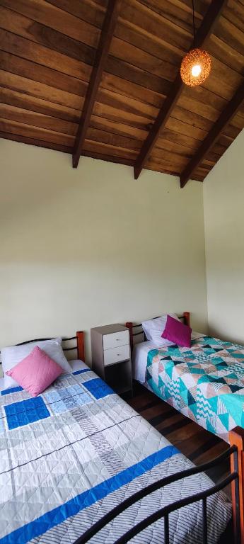 Postel nebo postele na pokoji v ubytování Casa Arthémis - Guapiles