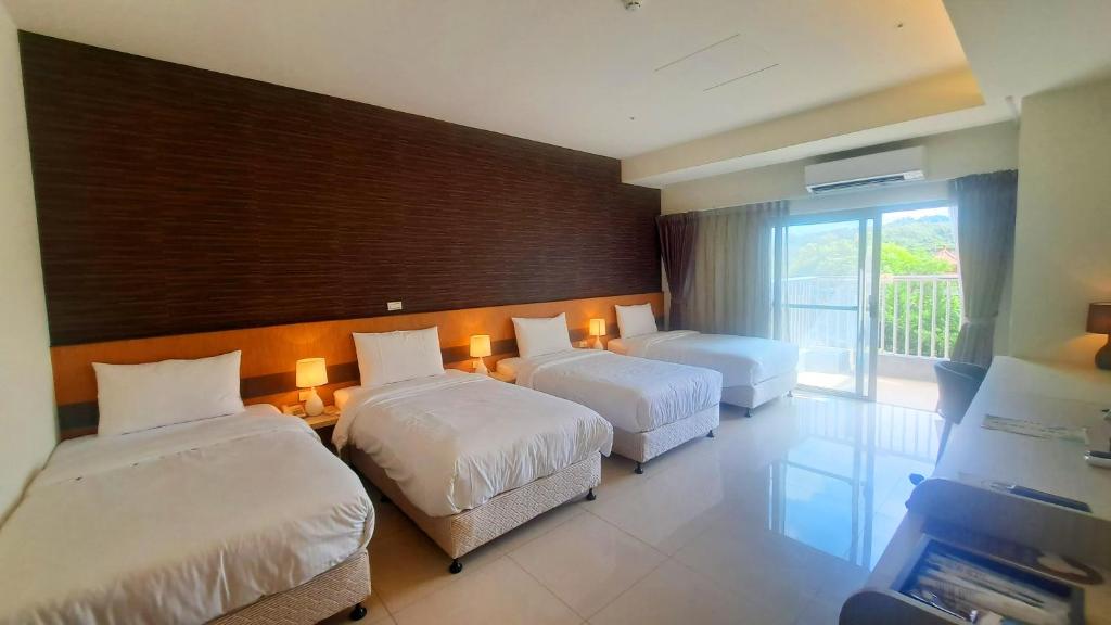 Postel nebo postele na pokoji v ubytování Zu San HOTEL