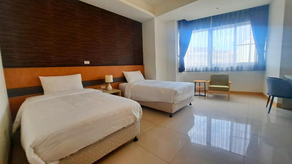 Postel nebo postele na pokoji v ubytování Zu San HOTEL