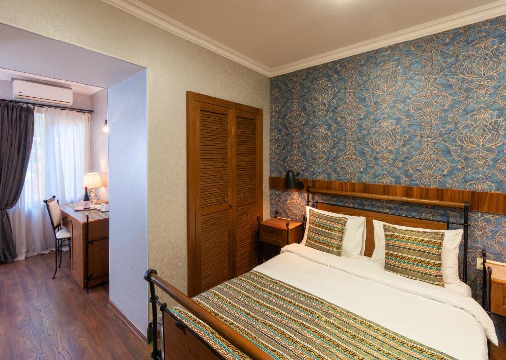 Postel nebo postele na pokoji v ubytování Wine Story Hotel & Club