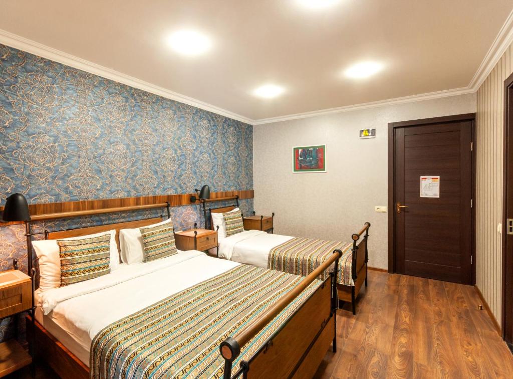 Postel nebo postele na pokoji v ubytování Wine Story Hotel & Club