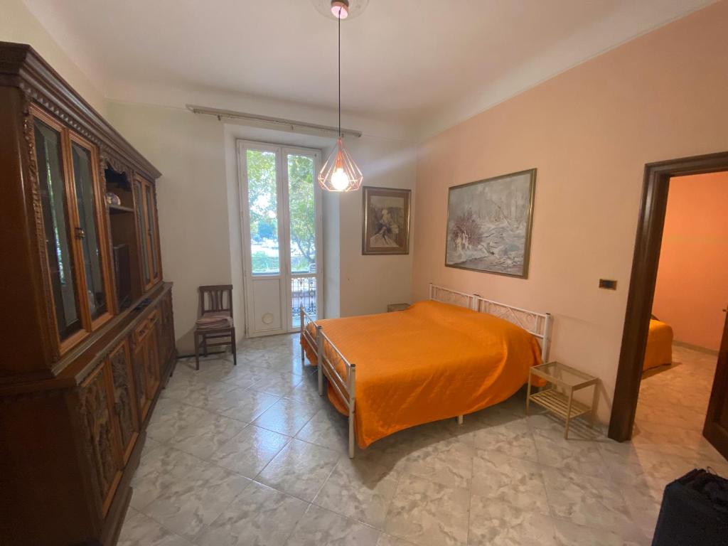 a bedroom with a bed with an orange blanket at Bed'n Fast Savona in Savona