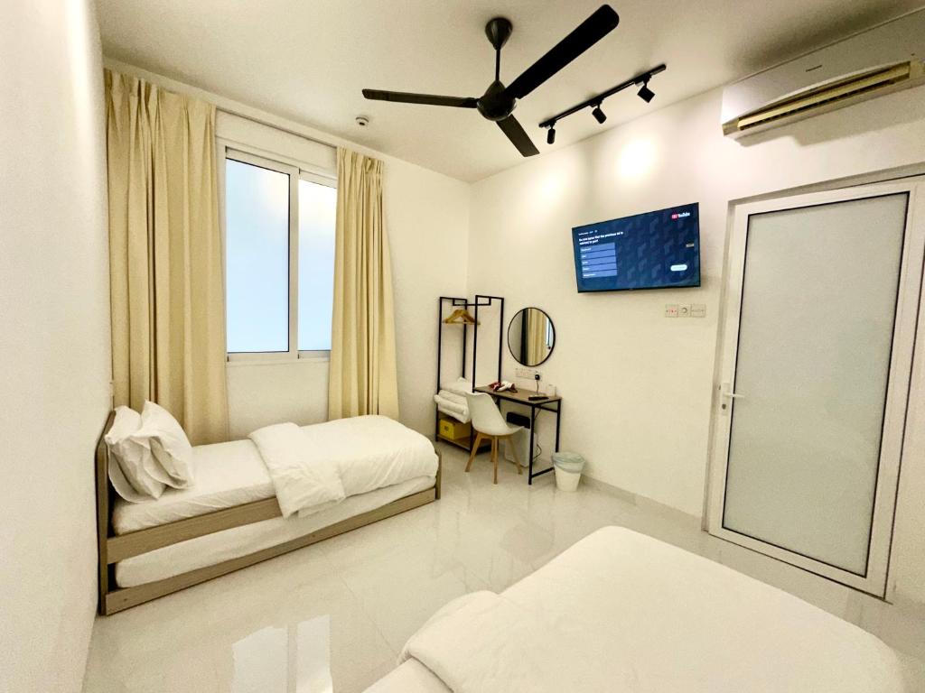 a white bedroom with a bed and a window at Stylish Cozy Landed Jelutong 3Room2bath4park 10pax in Jelutong