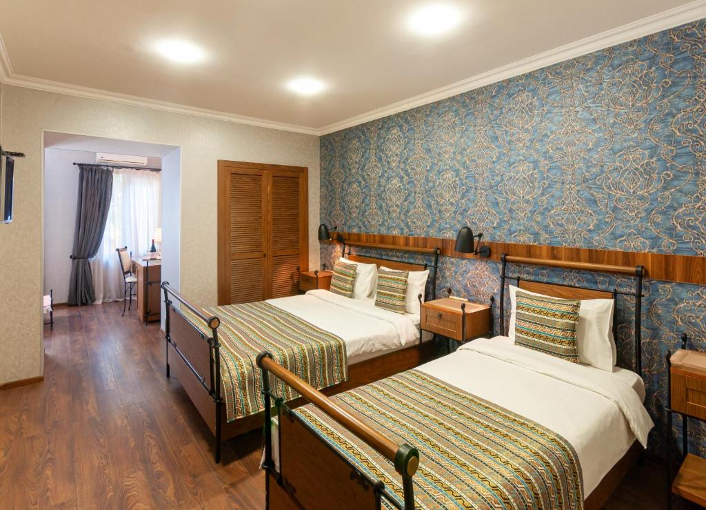 Postel nebo postele na pokoji v ubytování Wine Story Hotel & Club