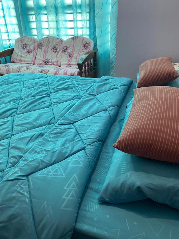 Postel nebo postele na pokoji v ubytování Seri Idaman Guest House (Pasir Mas)
