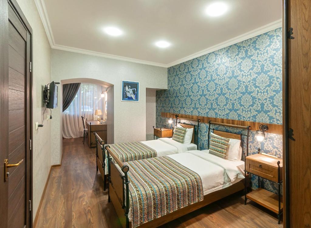 Postel nebo postele na pokoji v ubytování Wine Story Hotel & Club