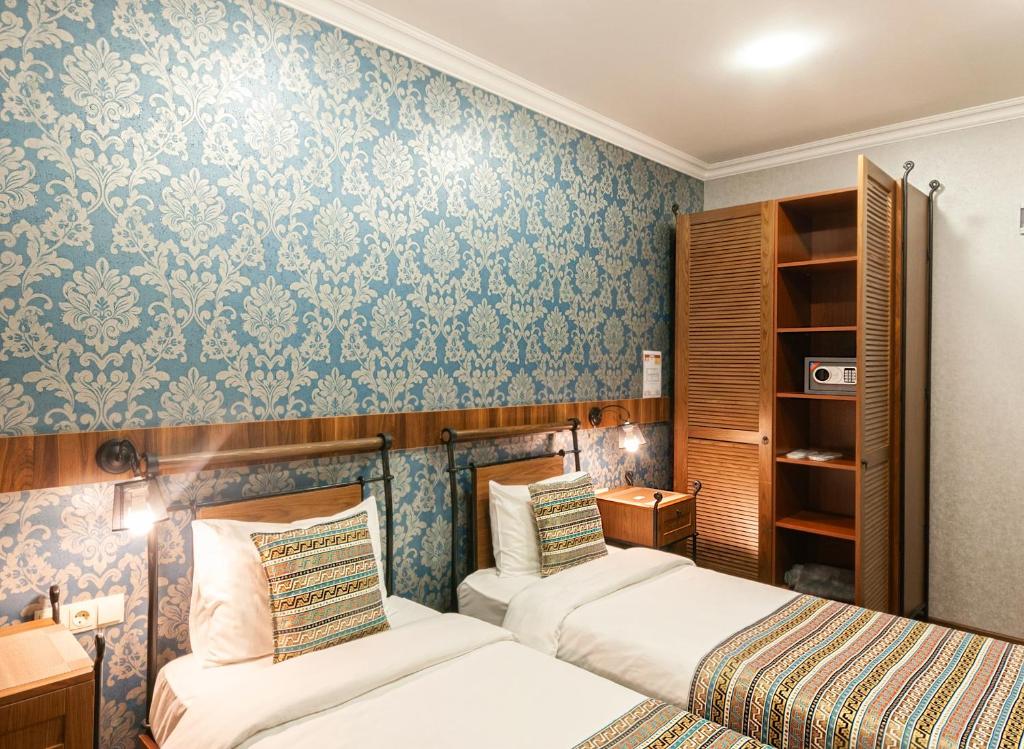 Postel nebo postele na pokoji v ubytování Wine Story Hotel & Club